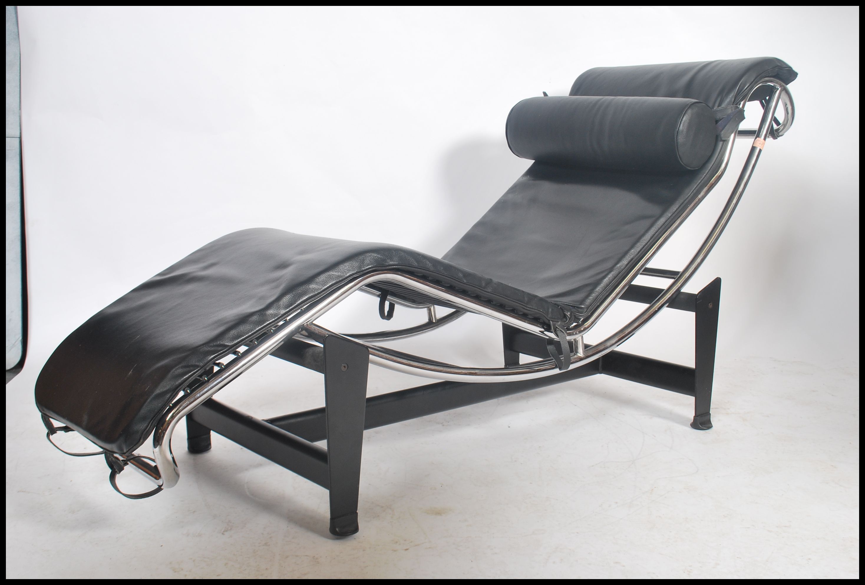 After Le Corbusier LC4 chaise lounge day bed with black leather upholstery and barrel cushion set