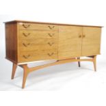 A good mid century Alfred Cox laurel wood / walnut sideboard raised on tapering legs having a shaped