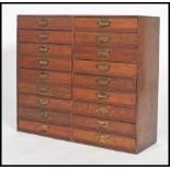 An oak 1930's haberdashery double bank chest of drawers being of small proportions comprising of