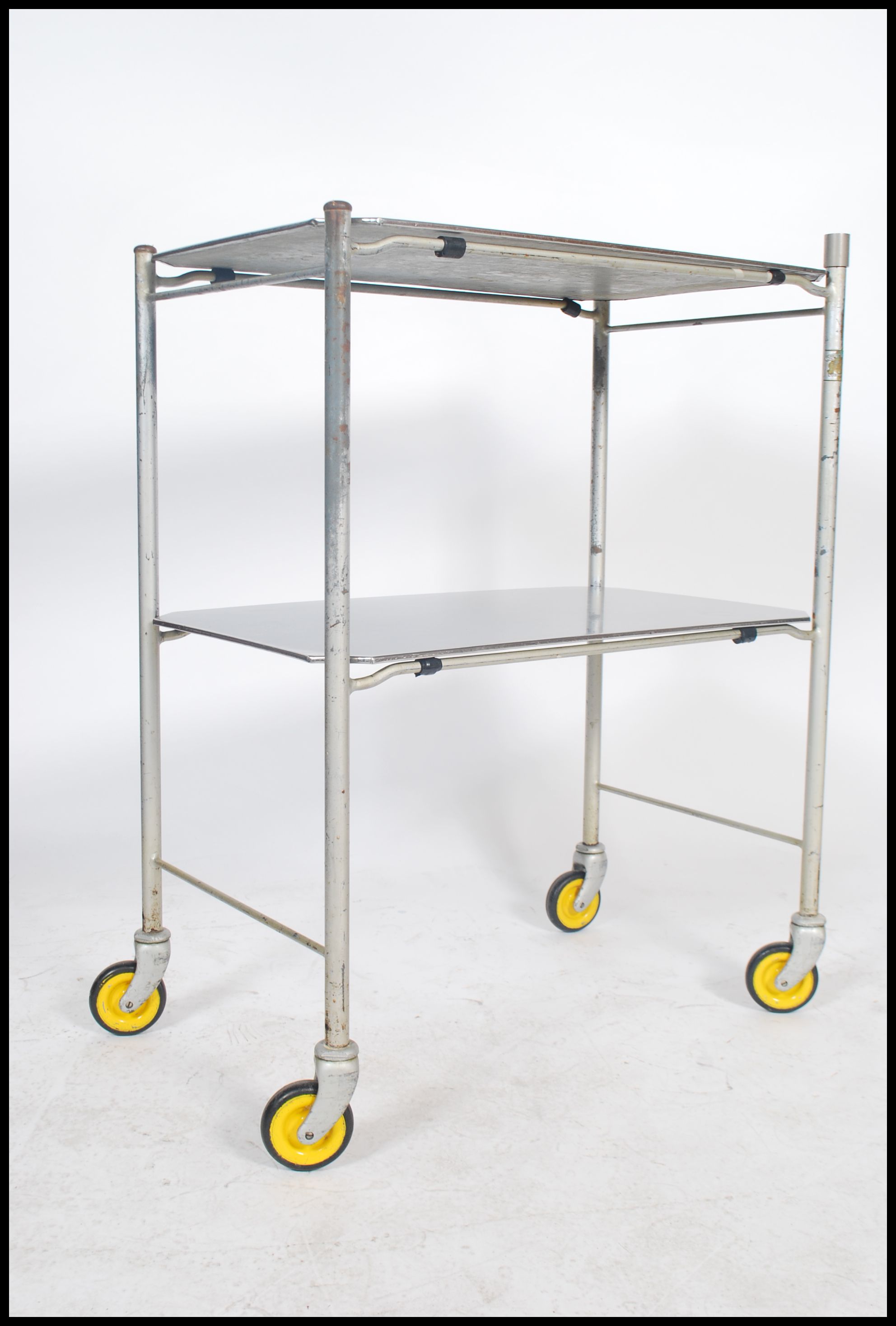 An original mid century Industrial surgeons theatre trolley of tubular metal and stainless steel