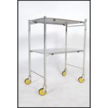 An original mid century Industrial surgeons theatre trolley of tubular metal and stainless steel