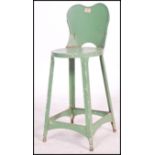 An early 20th century Industrial metal machinists stool / chair. Painted green with peripheral