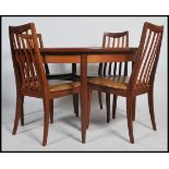 A stunning G-Plan teak extending dining table. Raised on tapered support with pierced and