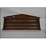 A late Victorian oak billiard score board comprising of a pointed arch pediment, painted numbers and