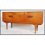 A good 1970's retro inverted teak wood sideboard dresser raised on tapering legs with inverted bow