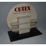 An original early 20th century Cutex shop display stand in two tone colourway with Art Deco style