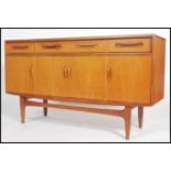 A 1970's G-Plan kelso teak wood sideboard of Danish influence having short drawers and cupboards