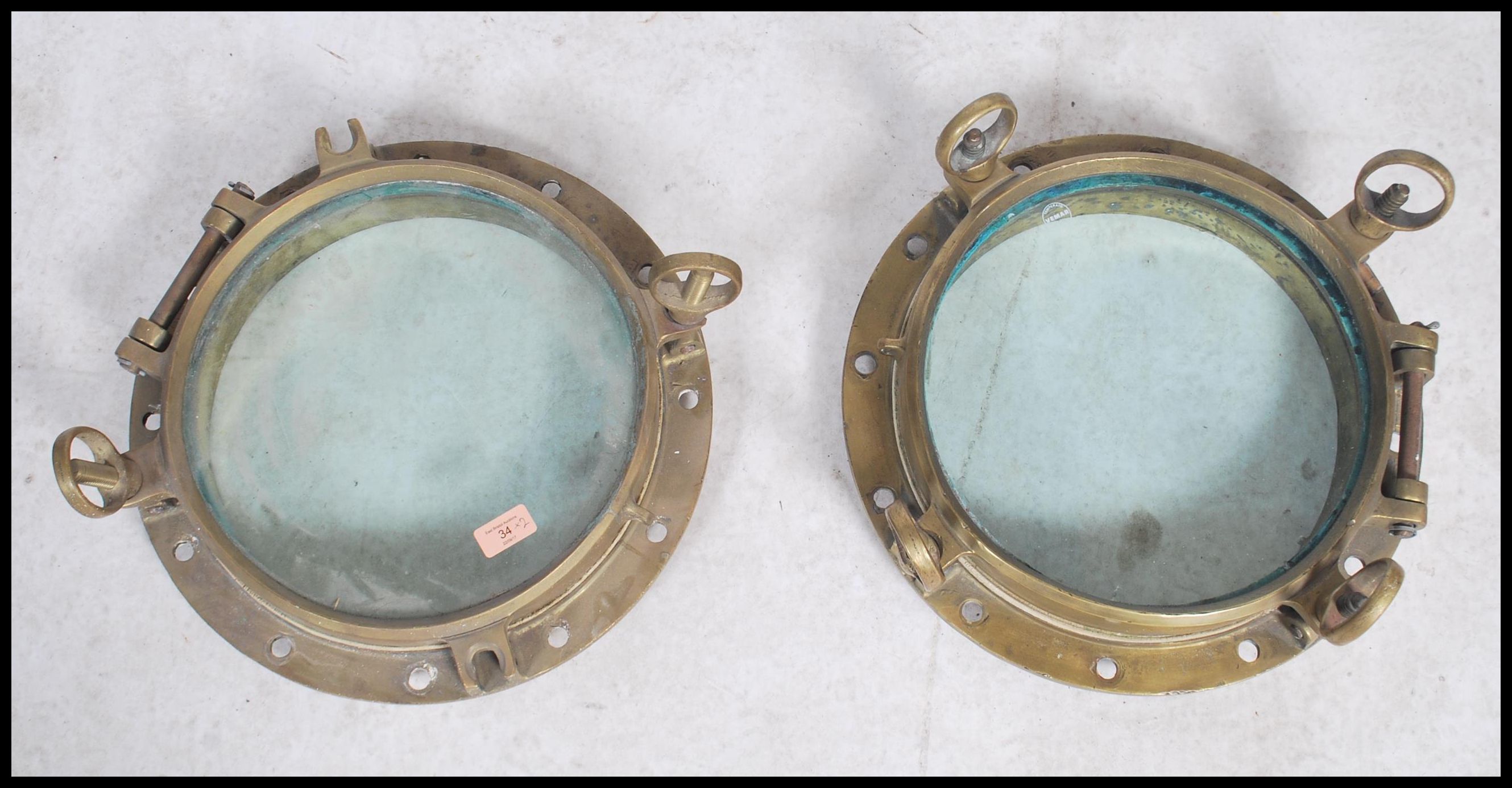 A stunning  early 20th century brass shipping porthole window's with backing plates on  fitted