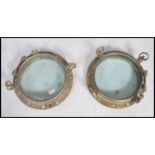A stunning  early 20th century brass shipping porthole window's with backing plates on  fitted
