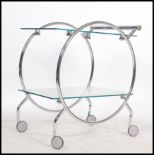 A 1930's style Art Deco chrome and glass butlers serving trolley. Raised on castors with circular