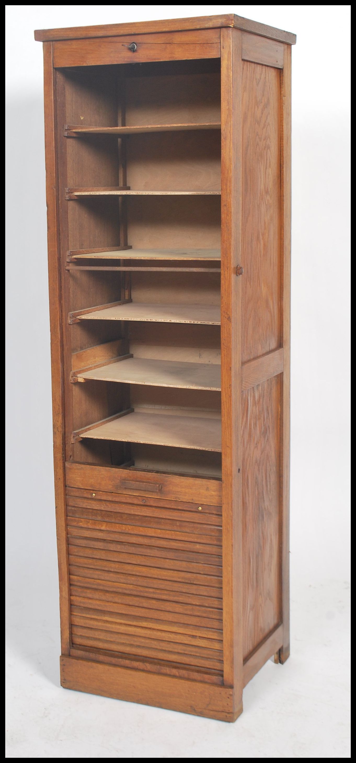 A 1920's oak tall  tambour fronted office Industrial filing cabinet raised on plinth base with - Image 2 of 4