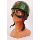 A rare and original early 20th century motor racing helmet and goggles set. The green helmet with