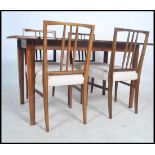 A 1950's Gordon Russell Llimited of Broadway, a believed laurel wood dining suite comprising of a