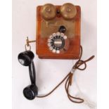 A vintage 20th century Wooden cased GPO telephone with ring dialer and original handset. THe rear of