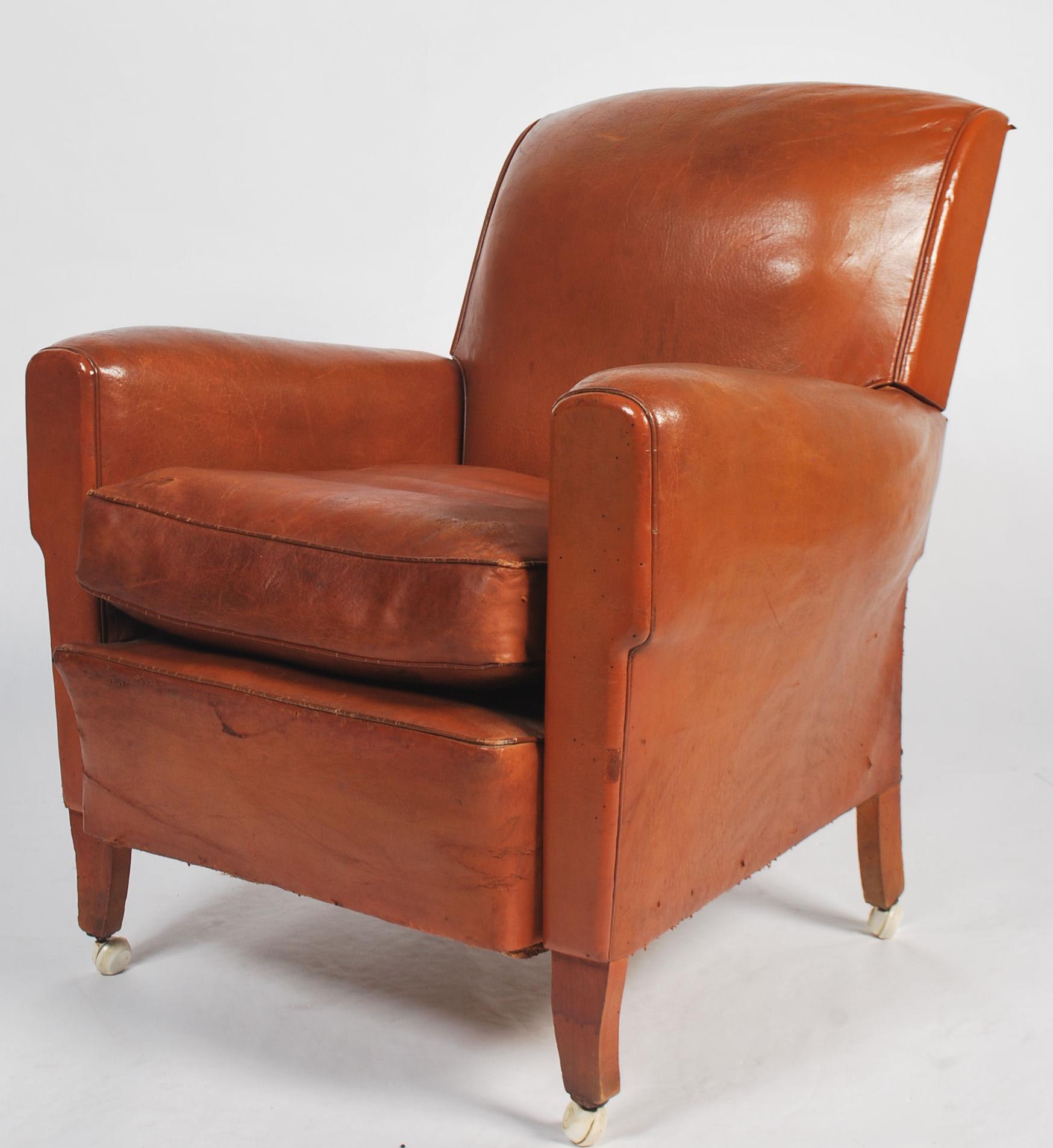 An exceptional 1930's Art Deco tan brown leather French club armchair being raised on leather