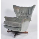 An original 1960's believed Parker Knoll black Batwing swivel chair - armchair being raised on