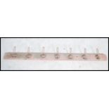 A set of seven vintage mounted early 20th century coat hooks each having an individual cast number