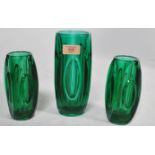 A 1960's retro 3 piece bullet glass garniture. The vases of green glass construction with