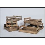A collection of 5 unusual wooden mid century apple crates of slatted construction having carry