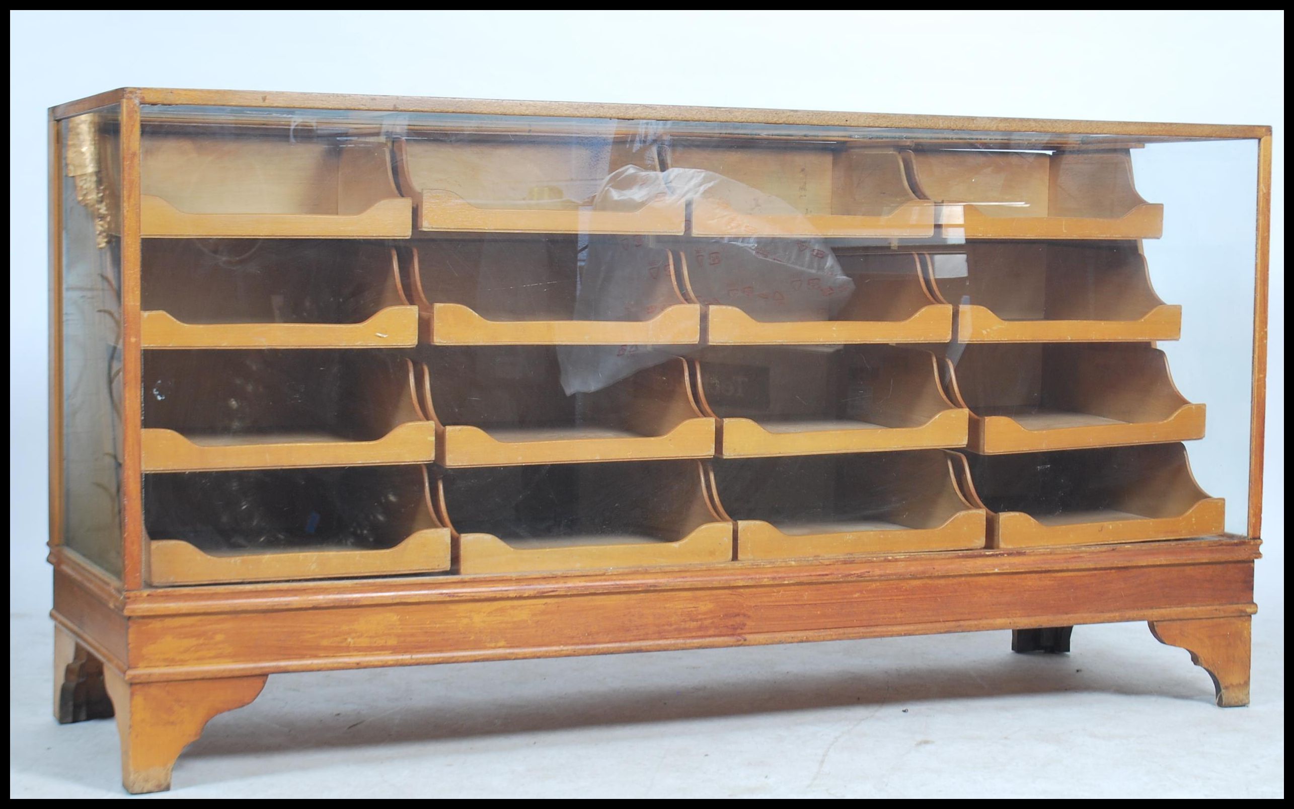 A stunning early 20th century sixteen drawer vintage haberdashery shop display cabinet counter