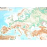 A large mid century school rubber map of Europe being embossed with raised mountain ranges -