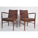 A pair of mid century Danish inspired teak wood armchairs. Each raised on tapering legs with