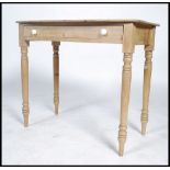 A Victorian country pine writing table being raise