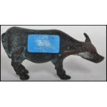 An early 20th century bronze figurine of a cow / y
