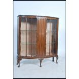 An Edwardian oak twin door display cabinet, fitted