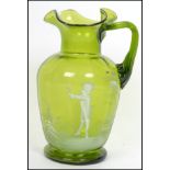 A 19th century Mary Gregory green glass ewer jug w