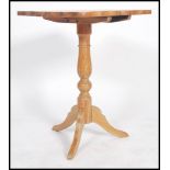 A Victorian country pine tilt top wine table raise