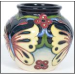 A Moorcroft tube lined squat vase decorated in the