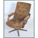 A 1970's brown corduroy swivel easy lounge armchai