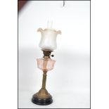 An early 20th Century oil lamp having a flute and
