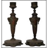 A pair of Victorian Backernalion bronze candle sti
