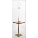 A 20th century brass and walnut standard lamp / occasional table raised on a brass and walnut base