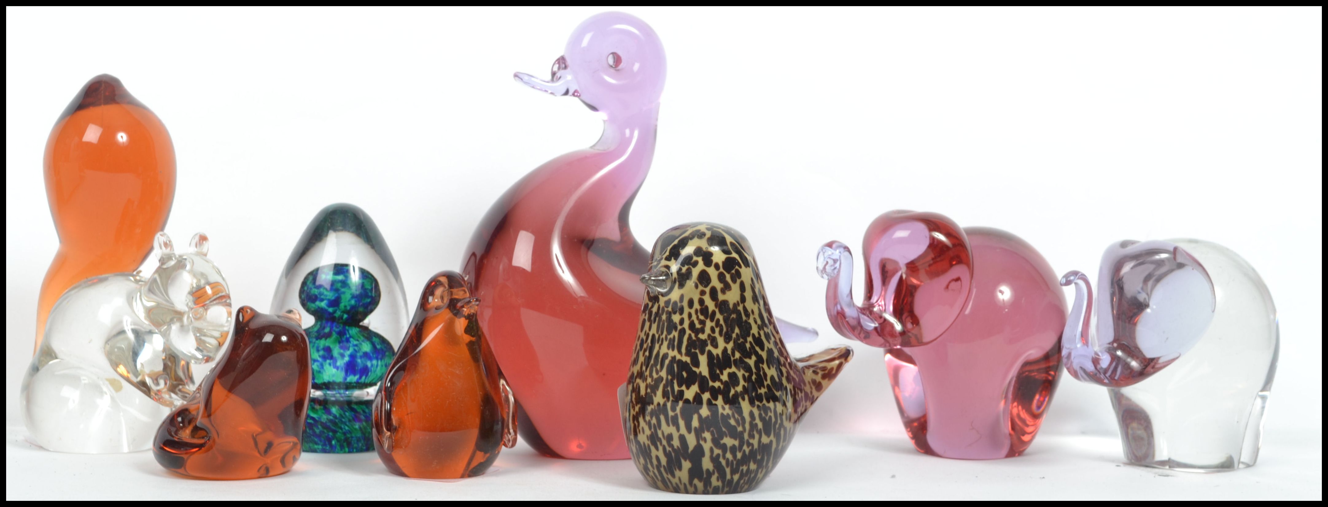 A collection of eight Wedgwood studio glass paperweights to include a cranberry glass Elephant, a