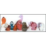A collection of eight Wedgwood studio glass paperweights to include a cranberry glass Elephant, a