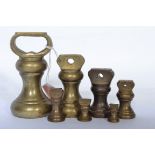 A graduating set of seven 19th century brass bell weights from 1 LB to 1/4 of an ounce.