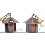 A pair of 20th century hanging porch lantern of octagonal form having leaded stained glass panels.