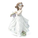 A Lladro ceramic figure of a girl holding a basket of flowers entitled floral path. Impressed