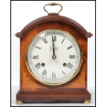 A Comitti of London mahogany cased bracket clock having a key wind mechanism striking on a bell with