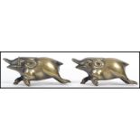 A pair of Oriental Chinese brass novelty figurines on the form of boars with horns. Measures: 3cm