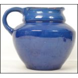 A large CH Brannam, Barum N Devon, large studio pottery dairy jug finished in a rich blue glaze,