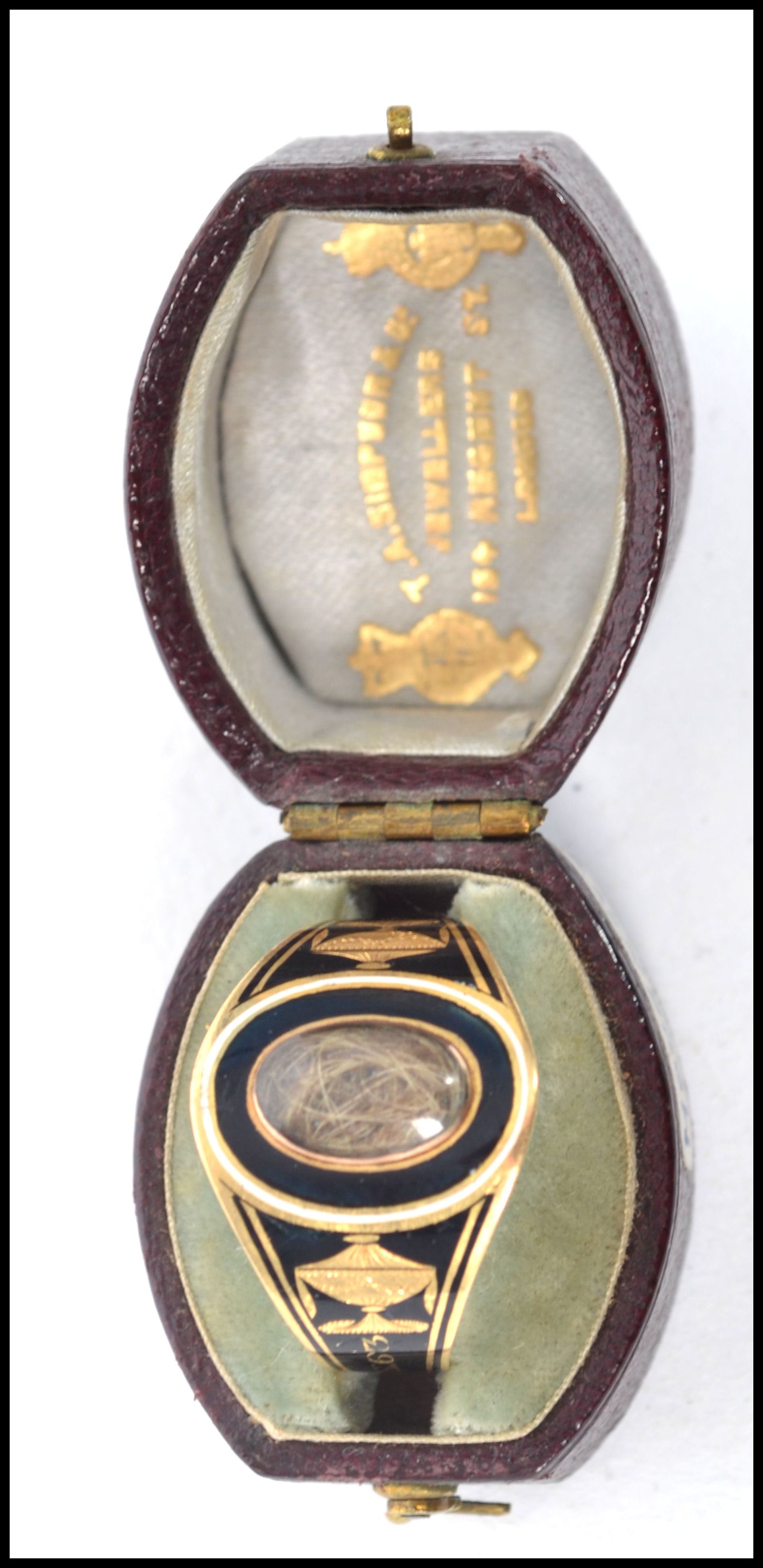 A George III Enamel, gold and hairwork mourning ring, the black enamel with white border lozenge
