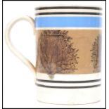 A 19th century Mocha ware tankard having a white ground with blue and black banded decoration and