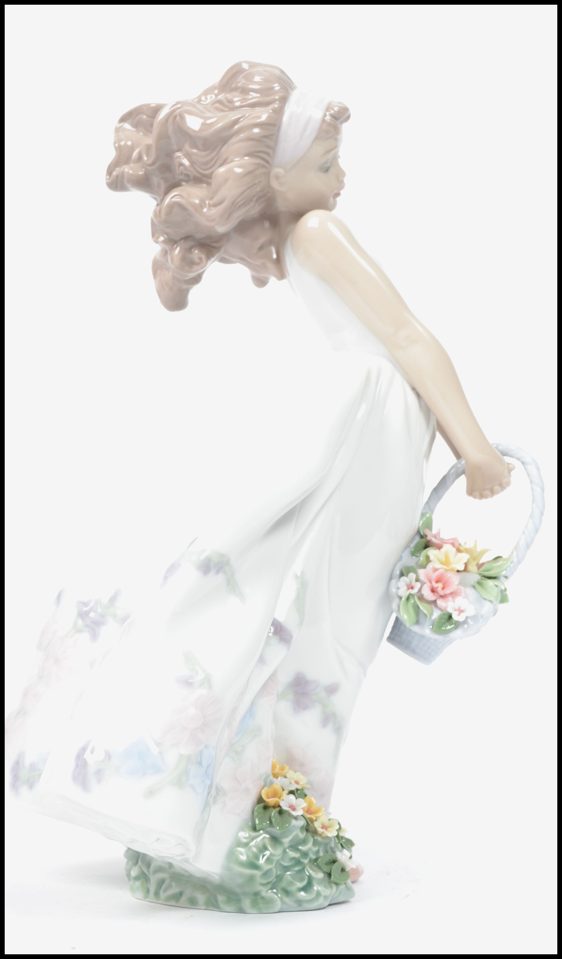 A Lladro ceramic figurine of a girl in dress holding a flower basket with floral bush to base. - Image 2 of 5