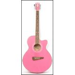 A Carlo Robeli vintage Carly six string acoustic guitar in pink having a shaped hollow body.