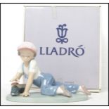 A Lladro ceramic figure titled " All Aboard ". No. 07619, retaining original box. Measures: 12cm