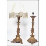 A pair of 20th century gilt bronze table lamps having a rococo design raised on a tripod base highly